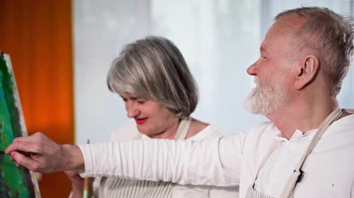 Senior Couple Creating Abstract Art Together at Home