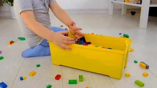 Child Playing with Toy Blocks in Home