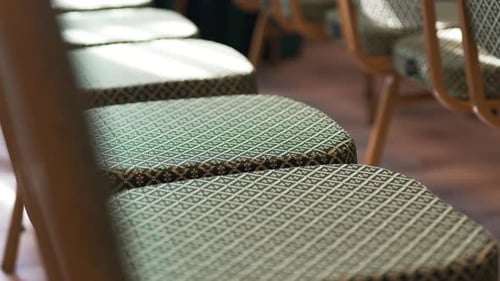 Green Upholstered Chairs with Intricate Diamond Patterns in Row