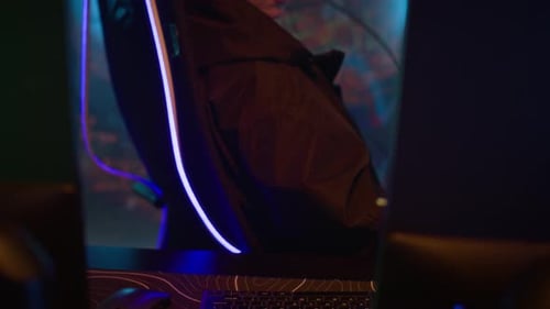 Woman in gaming chair looks at computer screen