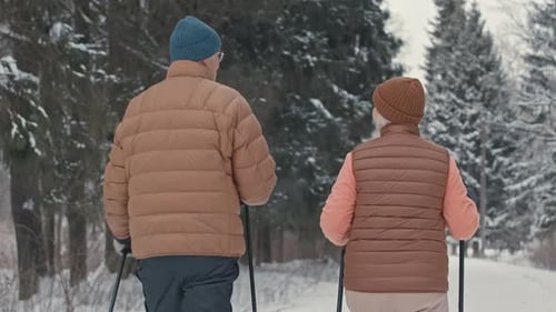 Senior Couple Nordic Walking Back View