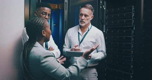 IT Workers Talking in Dark Data Center