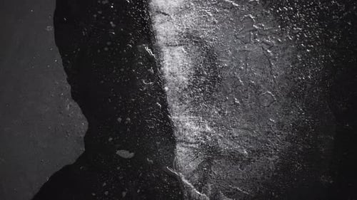 Water Trickling on a Dark, Textured Surface