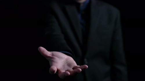 Man Presents a Digital Circuit Board in Hand