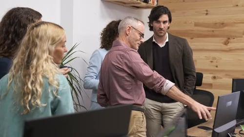 Manager Discussing Details of Project with Colleagues in Office