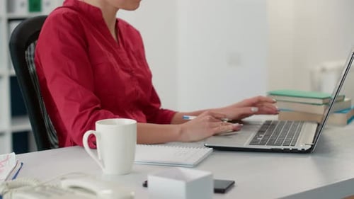 Company Accountant Using Sales Report to Take Notes