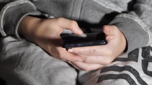 Child Using Cell Phone Close Up Indoors