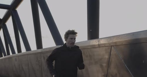 Adult man running athlete sprinting workout challenge training endurance in urban city