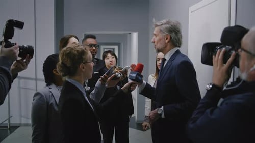 Representative of the European Union Surrounded By Crowd of TV News Journalists