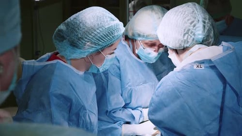 Team of Surgeons Performing Operation in Operating Room