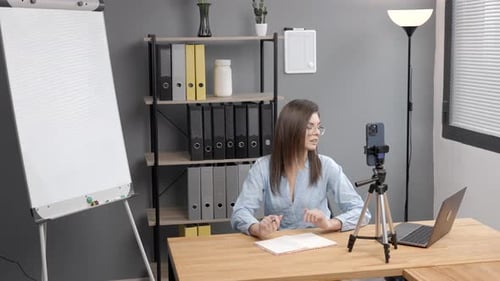 Woman Recording Video Blog in Office Setting