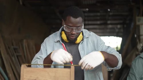 Carpenter make furniture at workshop.