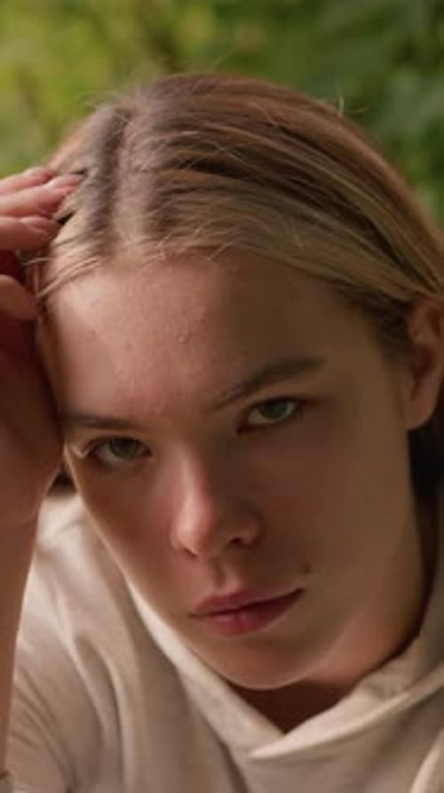 Close-up of contemplative young woman in outdoor setting