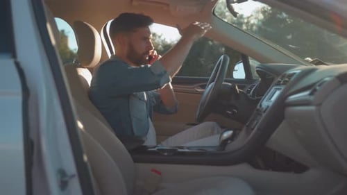 Man Talking on Phone in Car