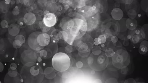 Floating abstract particle bokeh on dark background. Shot on super slow motion camera 1000 fps.