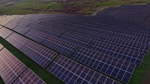 Large solar panel installation on green land in bright sunlight