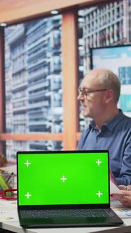 Laptop Green Screen in Modern Office Meeting