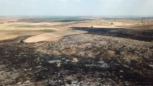 Aerial footage over Burnt landscape in the desert