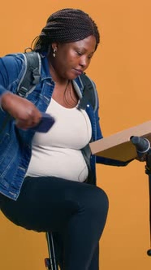 Adult Using Smartphone on Tripod in Studio