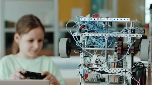 Girl Controls Robot at School Science Project
