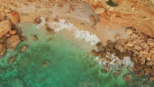 Turquoise Water Crashing on Secluded Sandy Beach Aerial View