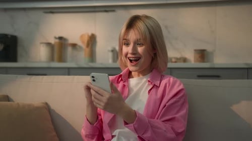 Woman Receives Exciting News on Mobile Phone