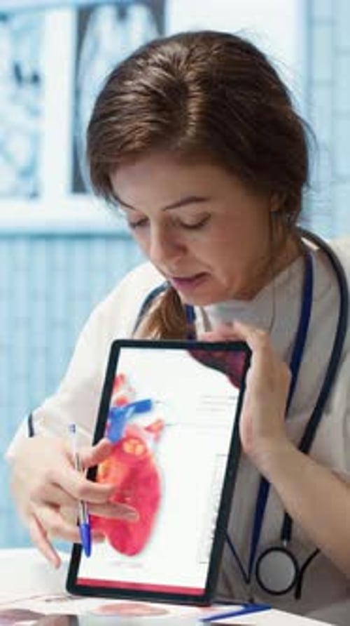 Vertical Video Healthcare Provider Cardiologist Explains Heart Function on a Cardiogram