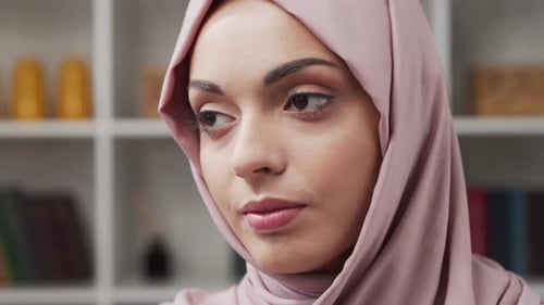 Woman Wearing Pink Headscarf Looking at Camera