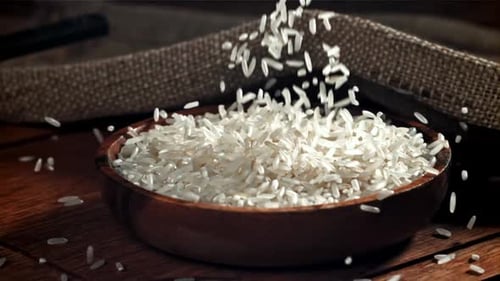 Rice is Poured Into a Wooden Bowl Filmed on a Highspeed Camera at 1000 Fps