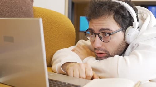 Surprised man watching documentary.