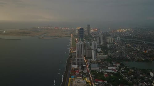 Fly High Above Sea Coast in City After Sunset Row of Luxurious Hotels at Seaside City Panorama with