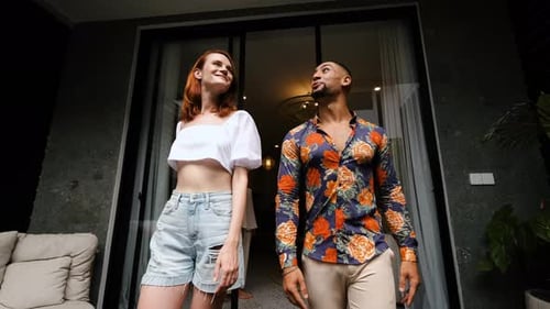 Couple Looking Upwards on Tropical Patio at Night