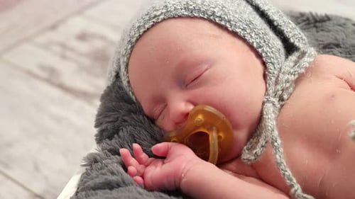 Baby Sucking a Dummy While Sleeping