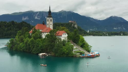 Lake Bled's famous landmarks, the island church and castle, aerial view