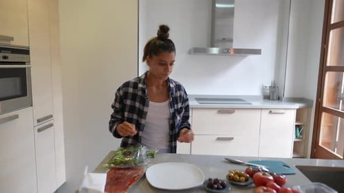 Young Woman Prepares Food in Kitchen