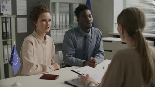 Young Diverse Couple Attending Immigration Interview at EU Embassy
