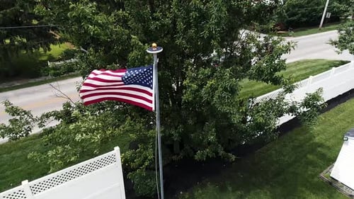 American Flag Waving on Sunny Day in Suburbs