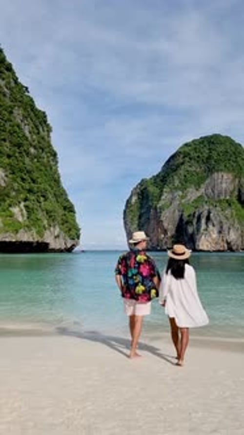 Couple Enjoying a Romantic Stroll on the Pristine Beaches of Koh Phi Phi Thailand