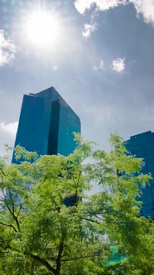 Time Lapse of Clouds Reflecting Into the Glass of a Large Office Building