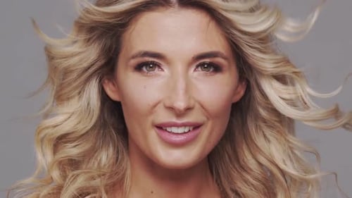 Studio Portrait of Young and Beautiful Blond Woman Over Grey Background Skin Care and Wellness