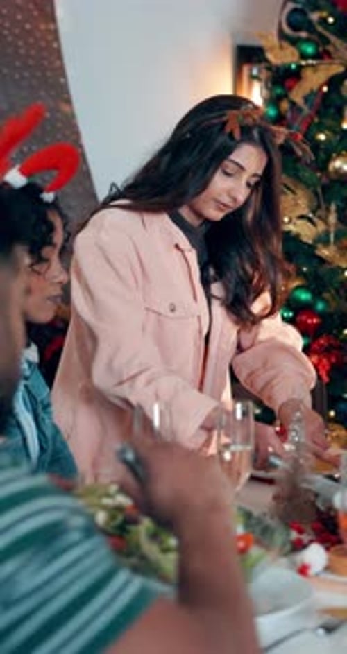 Group Gathered Around Table Enjoying Christmas Dinner