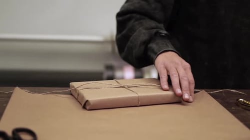 Gift Wrapped with Twine on Brown Paper