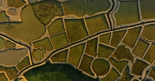 Aerial View of Xwejni Salt Pans Expansive Salt Pans Alongside a Historic Structure Natural Beauty
