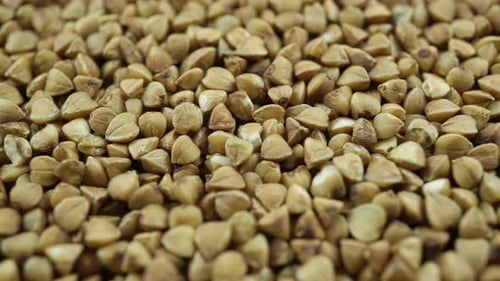 Close Up Of Rotating Raw Buckwheat Grains.