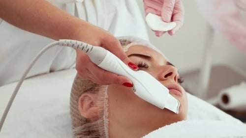 Beautician Using Ultrasonic Skin Scrubber for Exfoliation in Spa Salon Specialist Performing Gentle