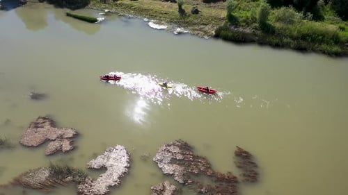 Aerial View Of Group Of People Canoeing On The River