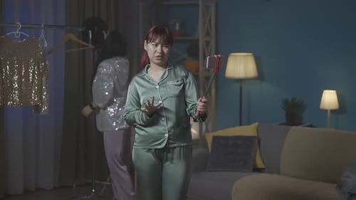 Two Young Adults Vlogging Fashion Choices Indoors