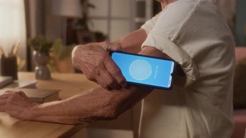Senior Person Checks Glucose Level on Smart Phone