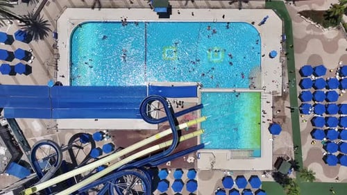 Aerial view of people sliding down a water slide at a water park
