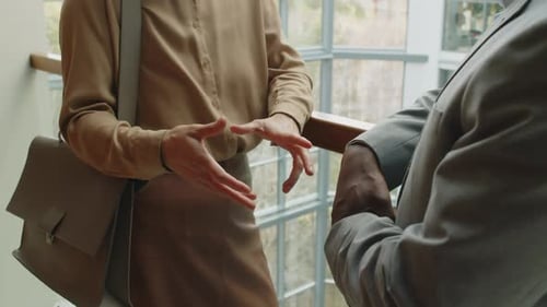 Business Partners Discussing Work Issues in Office Foyer